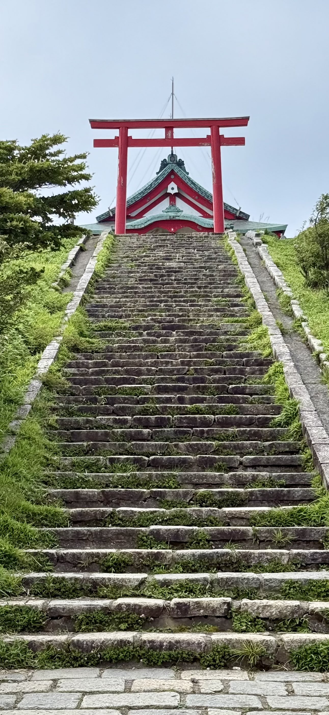 Tokyo tower standing in all its glory against a clear blue sky taken from the ground